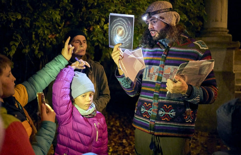 Kindern auf der Nachtwanderung wird das Universum erklärt mit Fotos